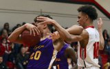 Lemoore's Damien Goudeau and Hanford's Juaron Watts-Brown battle for a rebound in the first of half of Wednesday's WYL season ending game.